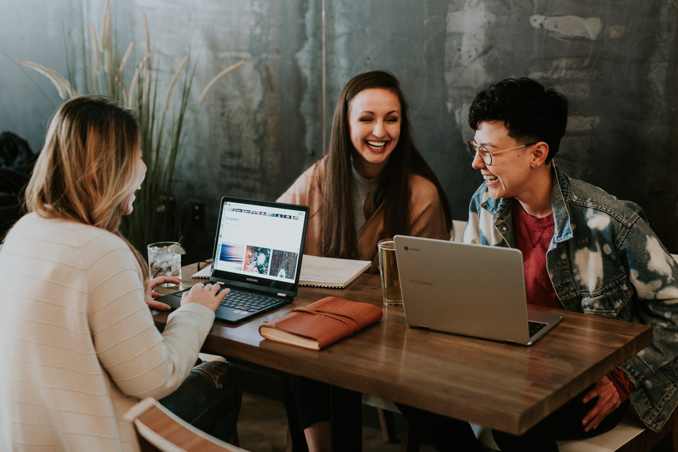 three millennial friends working at a coffee shop