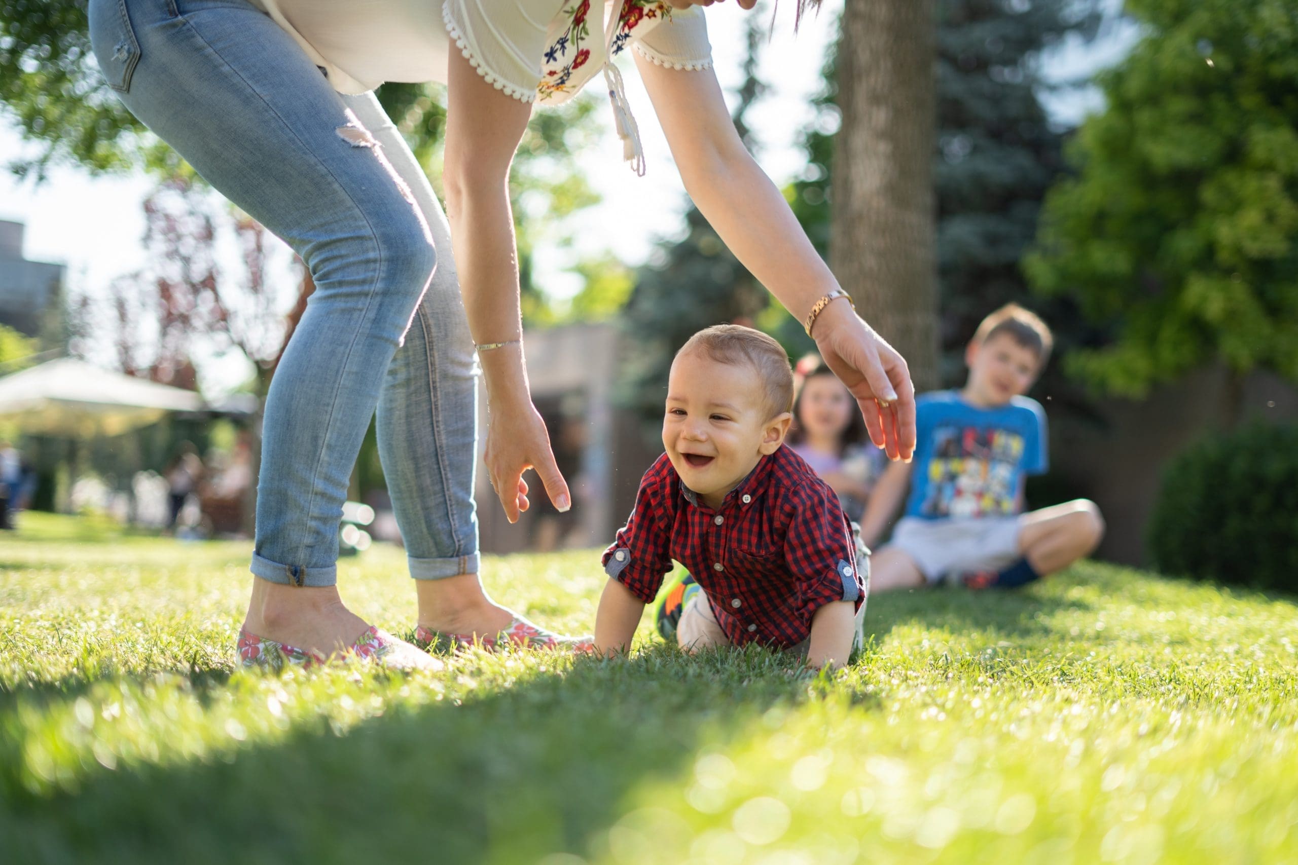 Family and kids playing at park